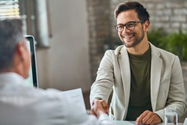 Happy Male Candidate Hand Shaking with Manager After Successful Job Interview Office